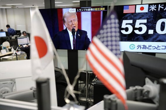 Stock market today: Asian shares trade mixed in a muted reaction to the U.S. inauguration